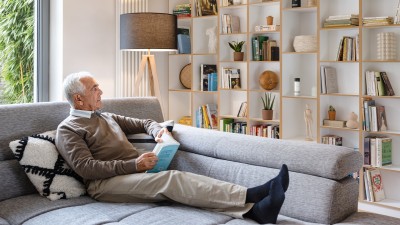 Senior sitzt auf Sofa und schaut zu Eyes Innenkamera